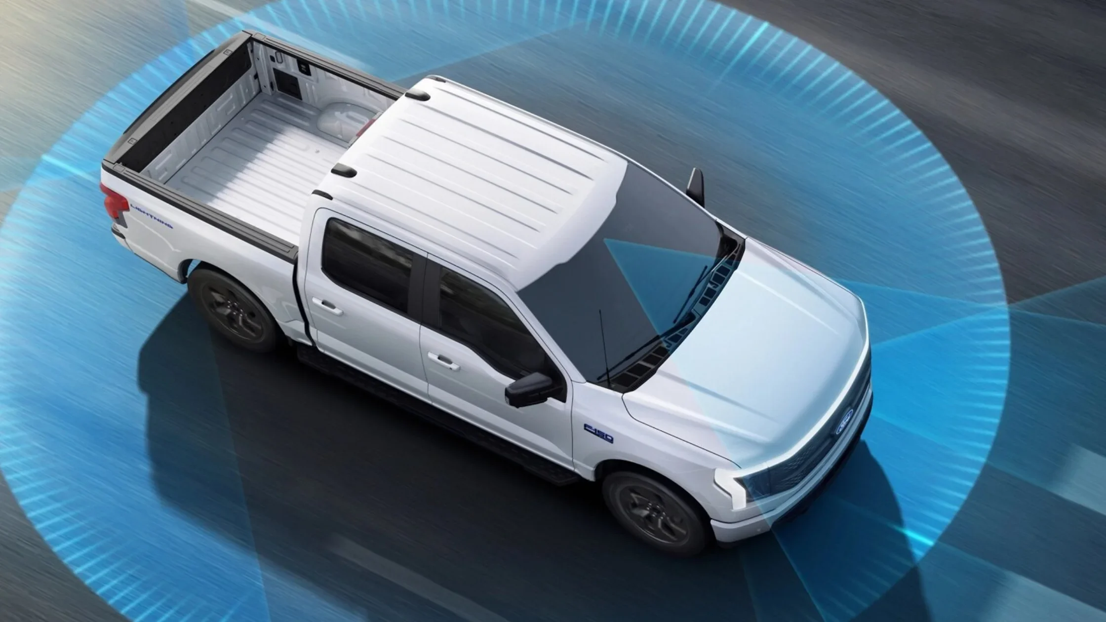 Top-down view of a white 2024 Ford F-150® Lightning with BlueCruise autonomous driving sensors highlighted.