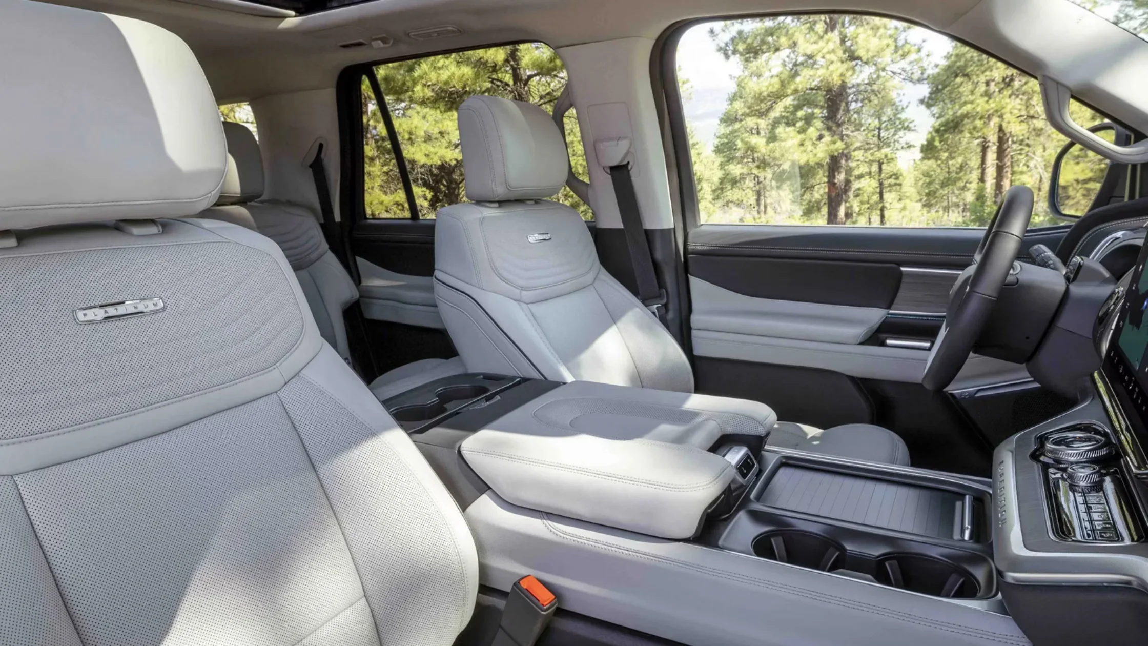 Front-row interior of 2025 Ford Expedition Platinum showing leather seating and center console detail.