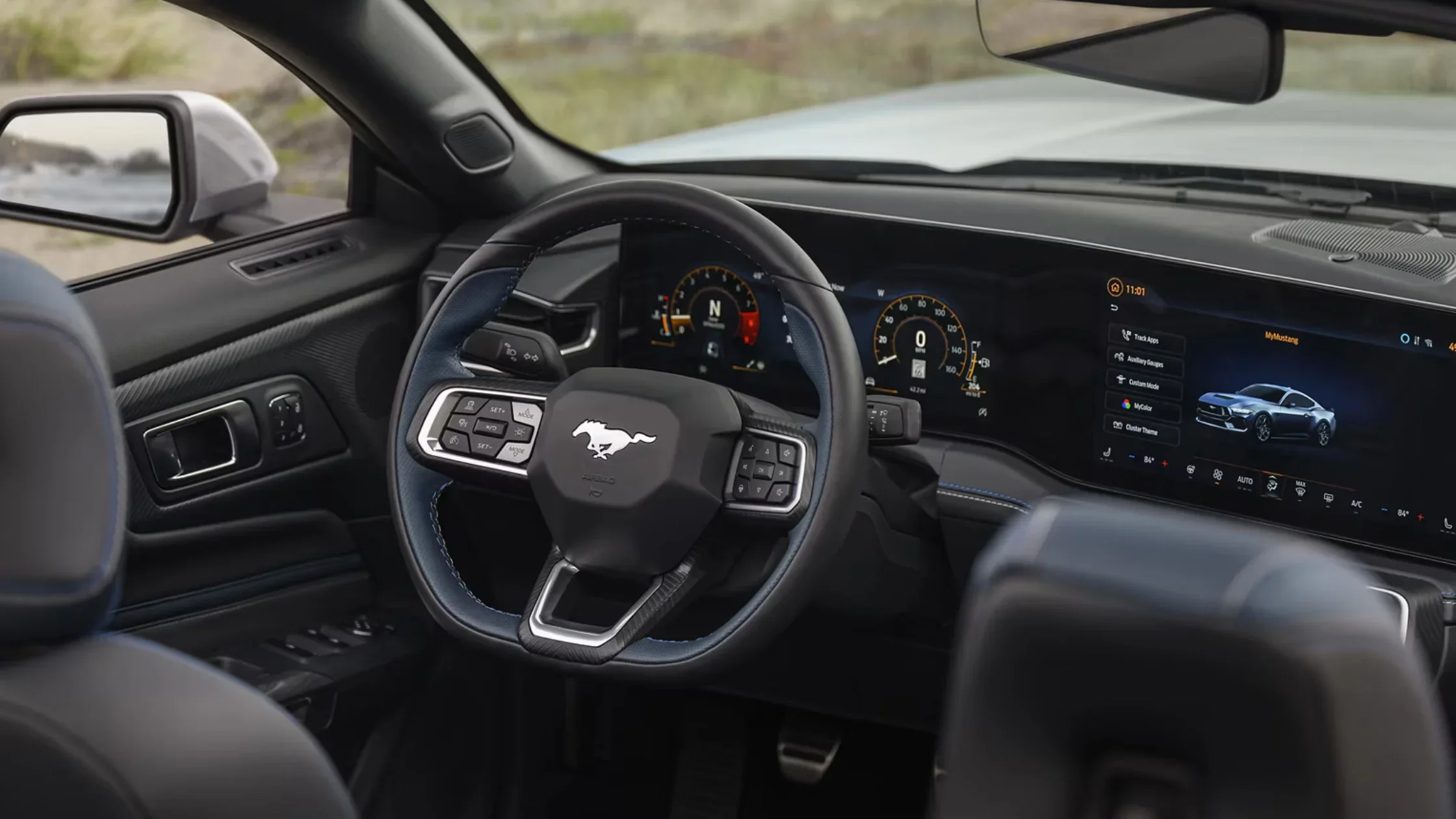 Driver’s view of the 2025 Ford Mustang® cockpit with digital instrument cluster and Mustang logo steering wheel.