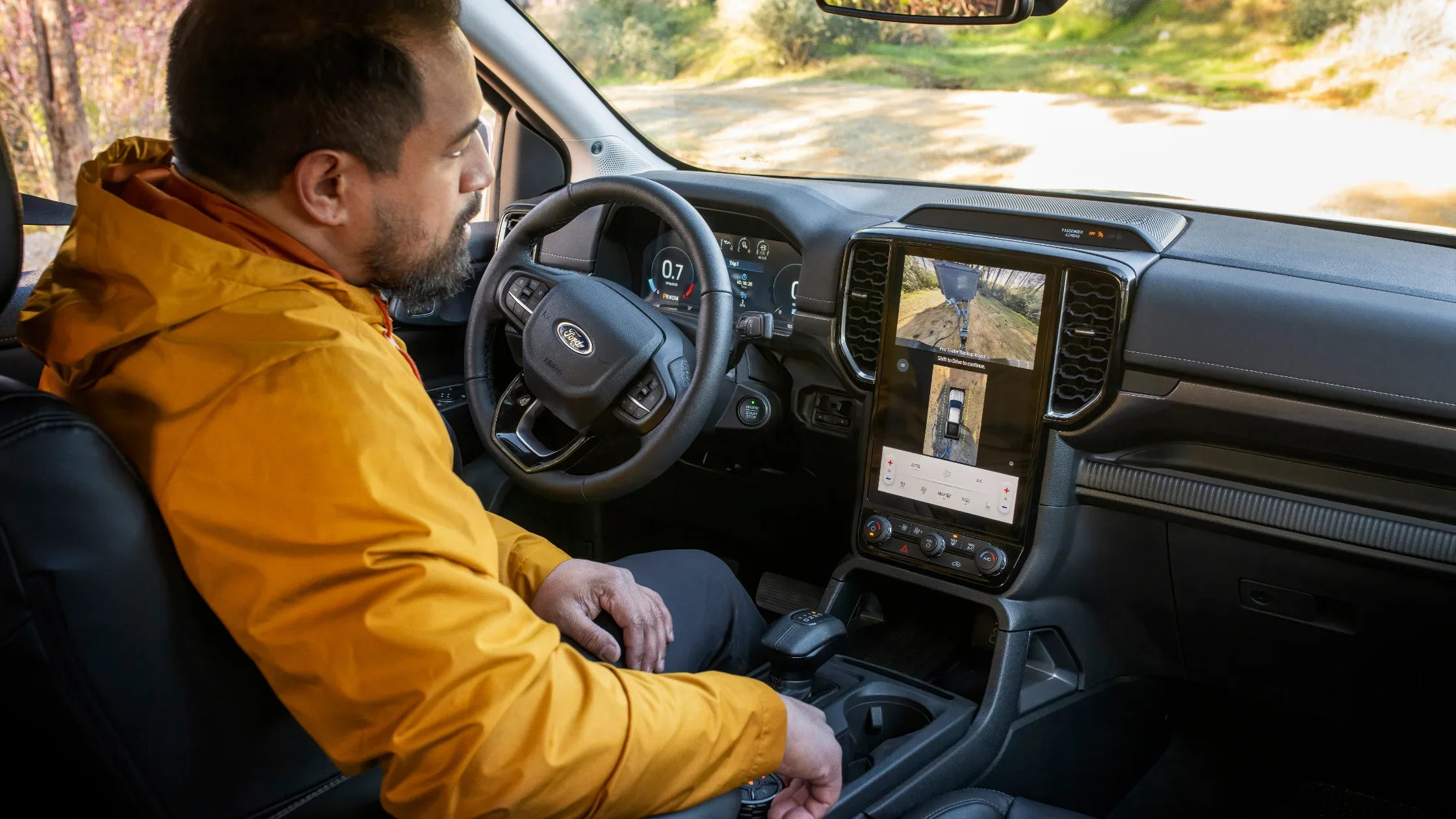 Man using 360-degree trailer view inside the 2025 Ford Ranger® pickup truck interior