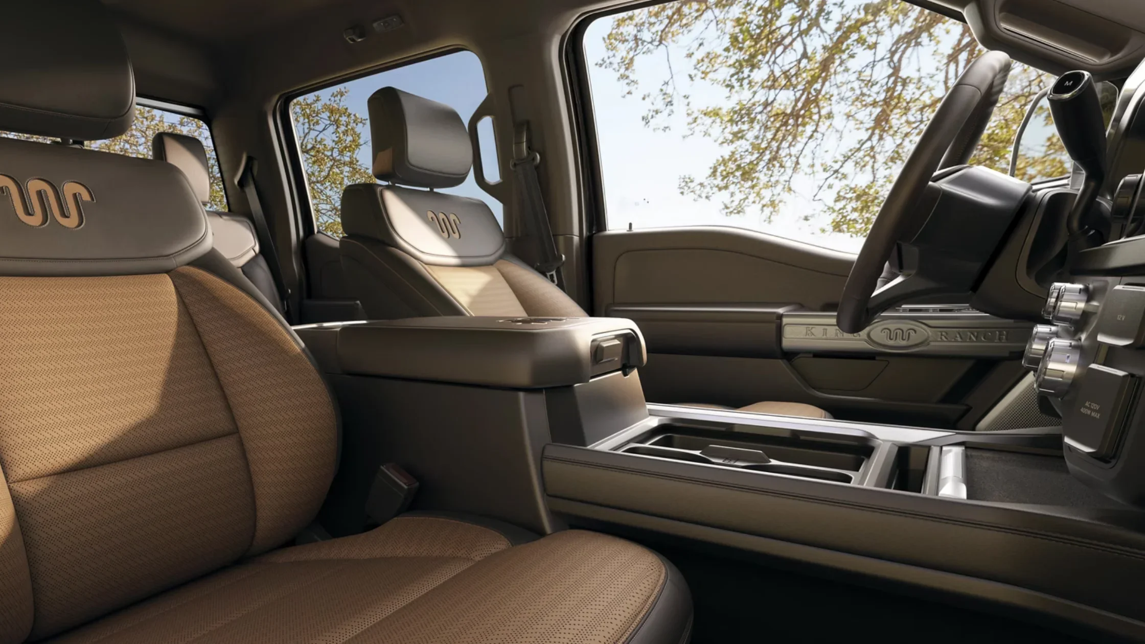 Interior view of 2025 Ford Super Duty® King Ranch with brown leather seats and King Ranch badging.